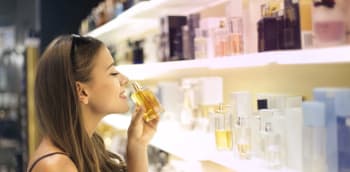 Smelling perfume from Duty Free display