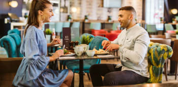Two people enjoying a breakfast at Cabin Bar, Leeds Bradford Airport