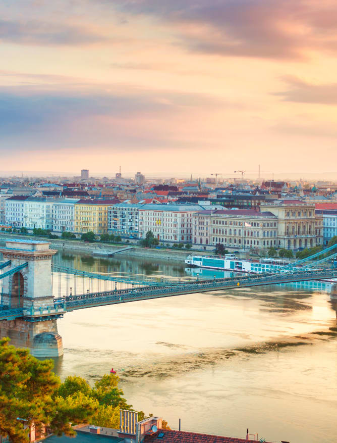 The Danube riverside in Budapest with Chain Bridge and river cruises