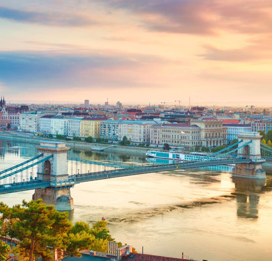 The Danube riverside in Budapest with Chain Bridge and river cruises