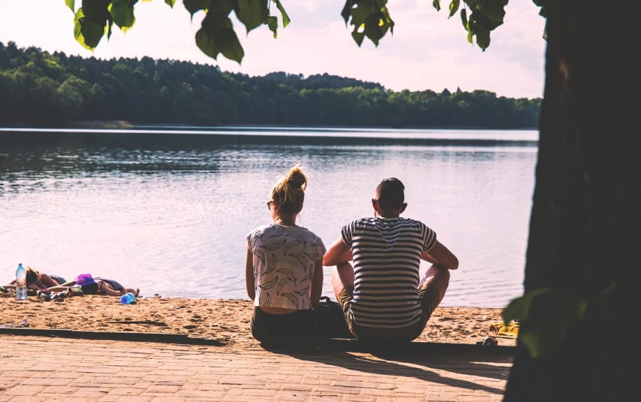 Couple relaxing at waterside